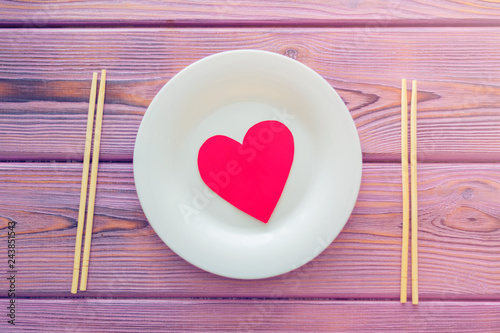 Love heart on a plate. The concept of nutrition love, heartwarming, losing weight because of love.