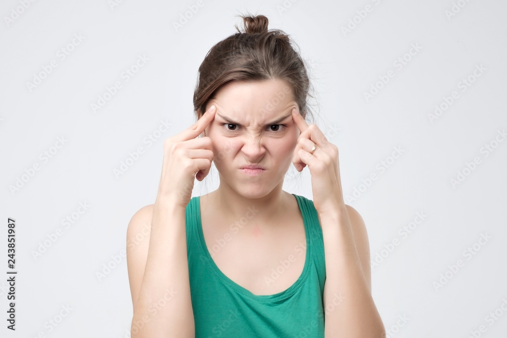 Pretty woman looking at camera with angry face Pretty woman looking at camera with angry face
