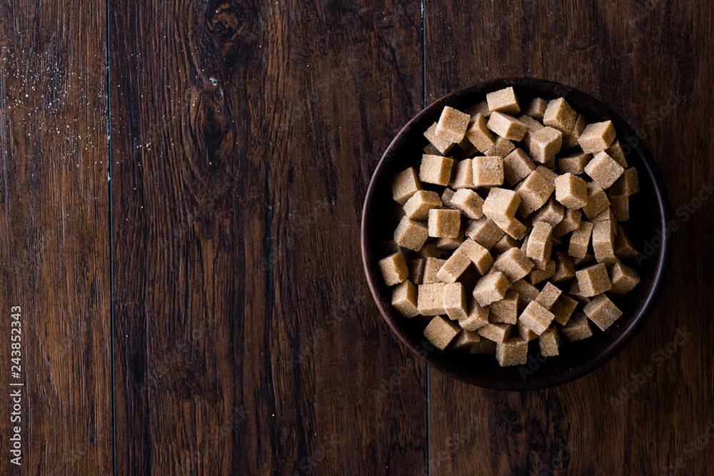 Raw Organic Brown Sugar Cubes in Wooden Bowl Ready to Eat. Raw Organic Brown Sugar Cubes in Wooden Bowl Ready to Eat.