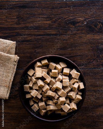 Raw Organic Brown Sugar Cubes in Wooden Bowl Ready to Eat.