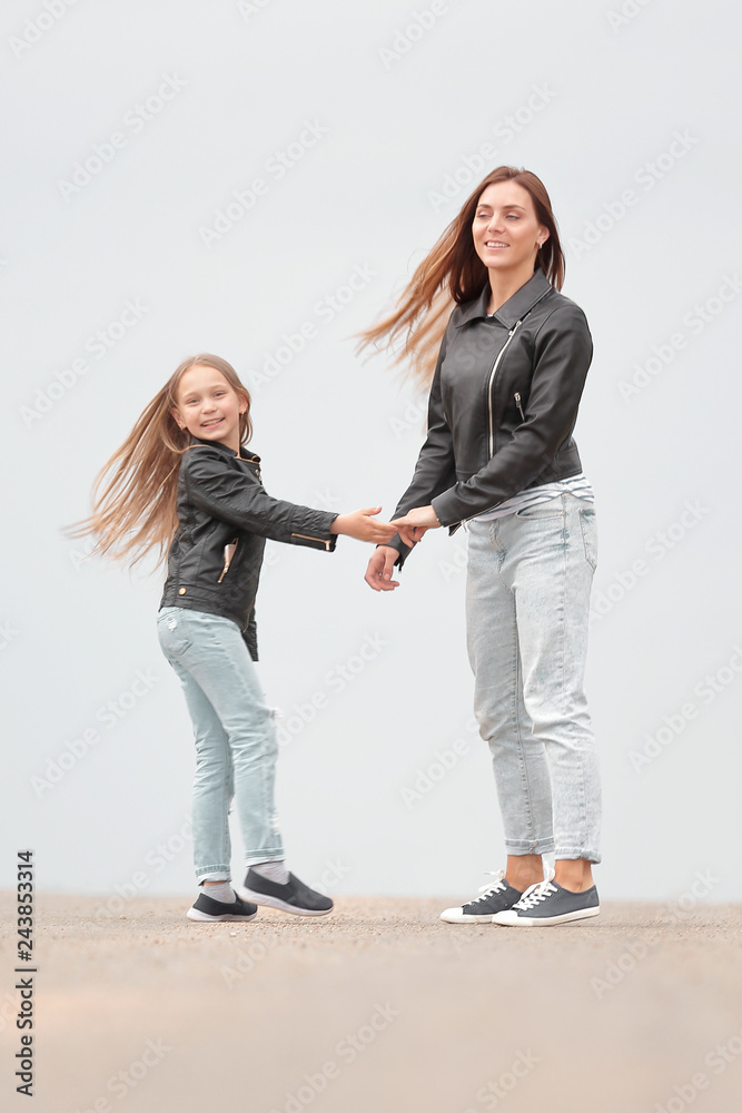 Fototapeta premium rear view. mother and daughter holding each other's hands