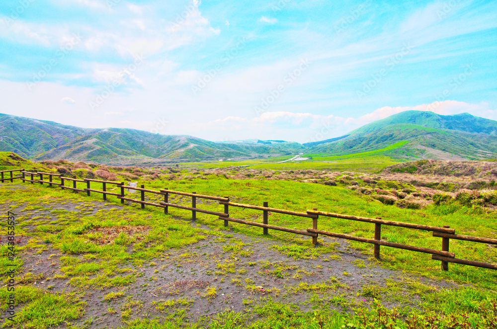 Beautiful landscape view of Kusasenri Ga Hama Grassland is green grass field for grazing with Mountain Eboshi-dake ,where is famous scenic spot in Aso Kuju National Park ,Kumamoto ,Kyushu ,Japan
