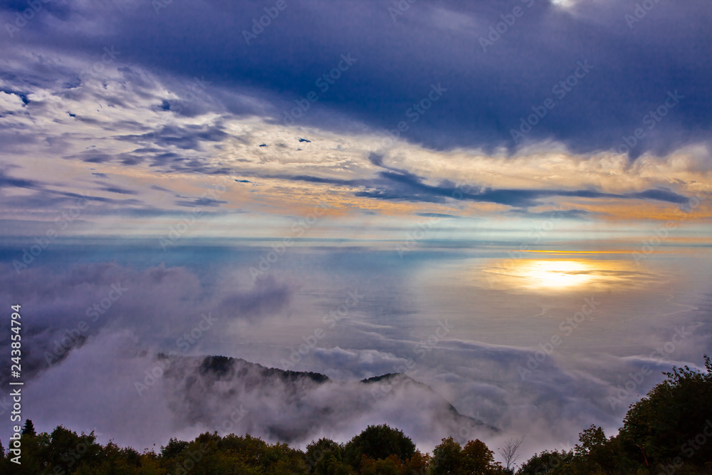 sunset sun is reflected in the sea, the view from the high mountain on the sea shore