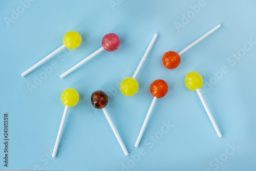 Lollipops on a blue background. Top view.