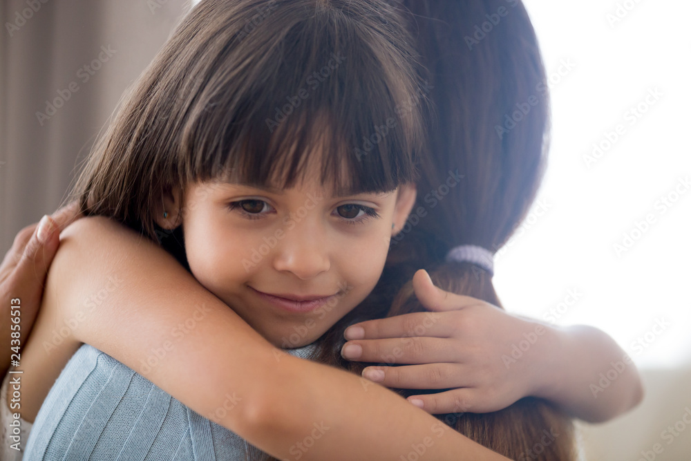 Cute little child girl embracing loving mother, happy kid hugging mom holding tight cuddling, sincere affectionate relationships between mum and daughter, moms love support care or adoption concept Cute little child girl embracing loving mother, happy kid hugging mom holding tight cuddling, sincere affectionate relationships between mum and daughter, moms love support care or adoption concept