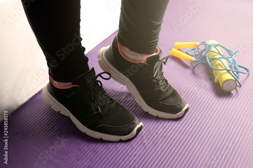 Morning exercise on a yoga mat with dumbbells and a skipping rope, exercise