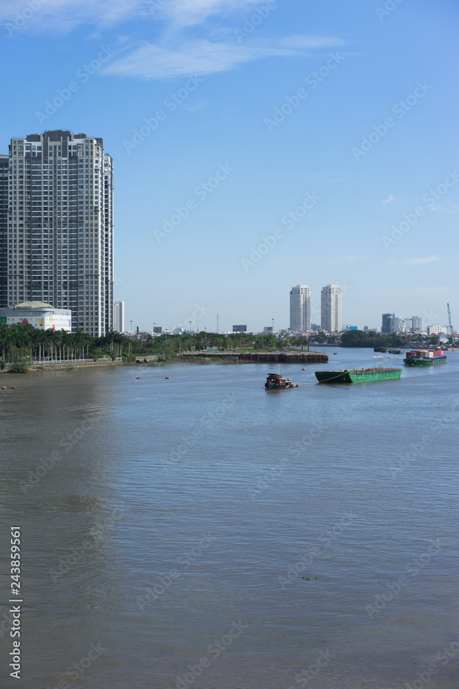 saigon river with blue sky and high building