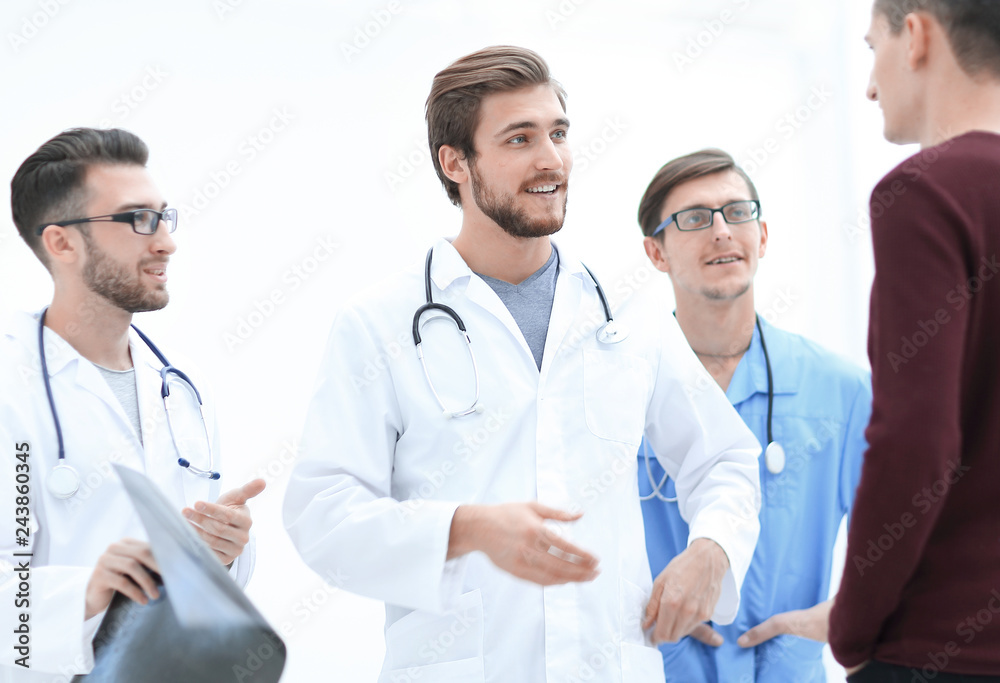 group of doctors discussing a patient's x-ray group of doctors discussing a patient's x-ray