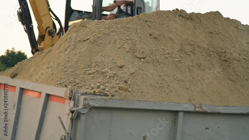 excavator loads a truck