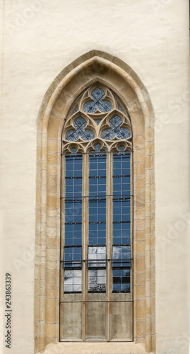 Old door on the façade of stone building © Oana