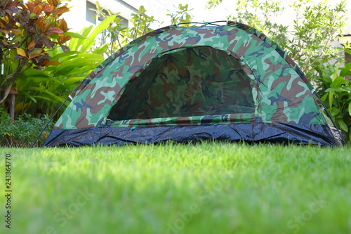 tent camping on green grass lawn campsite, equipment for trip backpack travel in nature