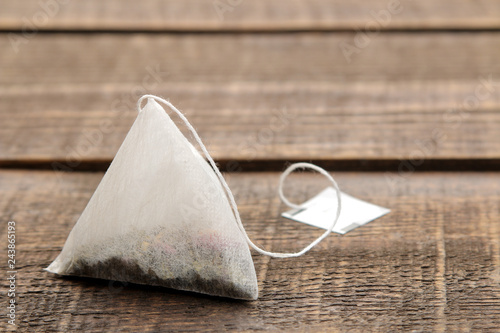 tea bag pyramid closeup on a brown wooden table. space for text photo