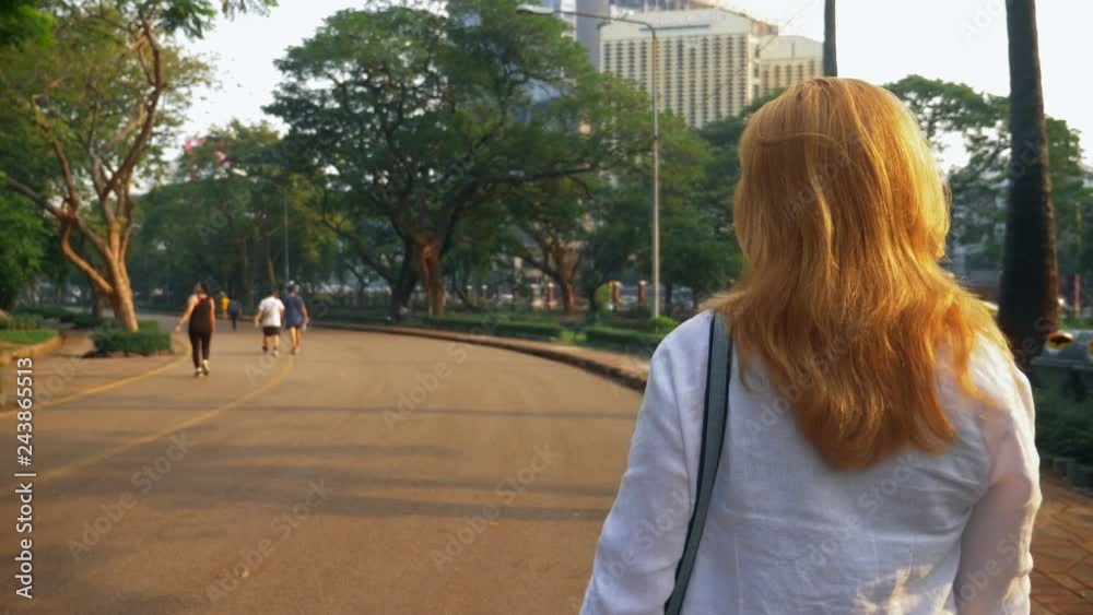Charming young woman with golden hair rushing in the city center. Charming young woman with golden hair rushing in the city center.