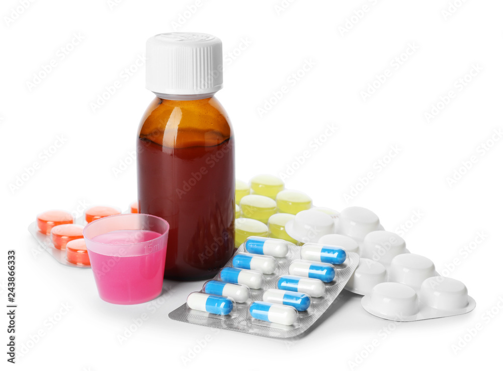 Bottle of cough syrup and different pills on white background Bottle of cough syrup and different pills on white background