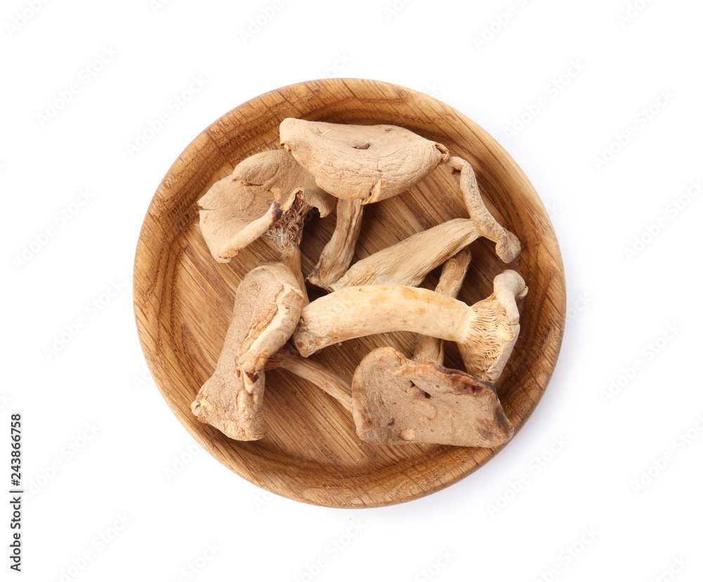 Plate of dried mushrooms isolated on white, top view