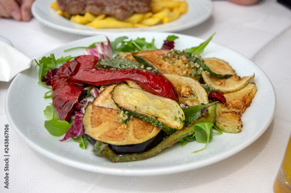 Fresh grilled vegetables on white plate, tasty and healthy lunch