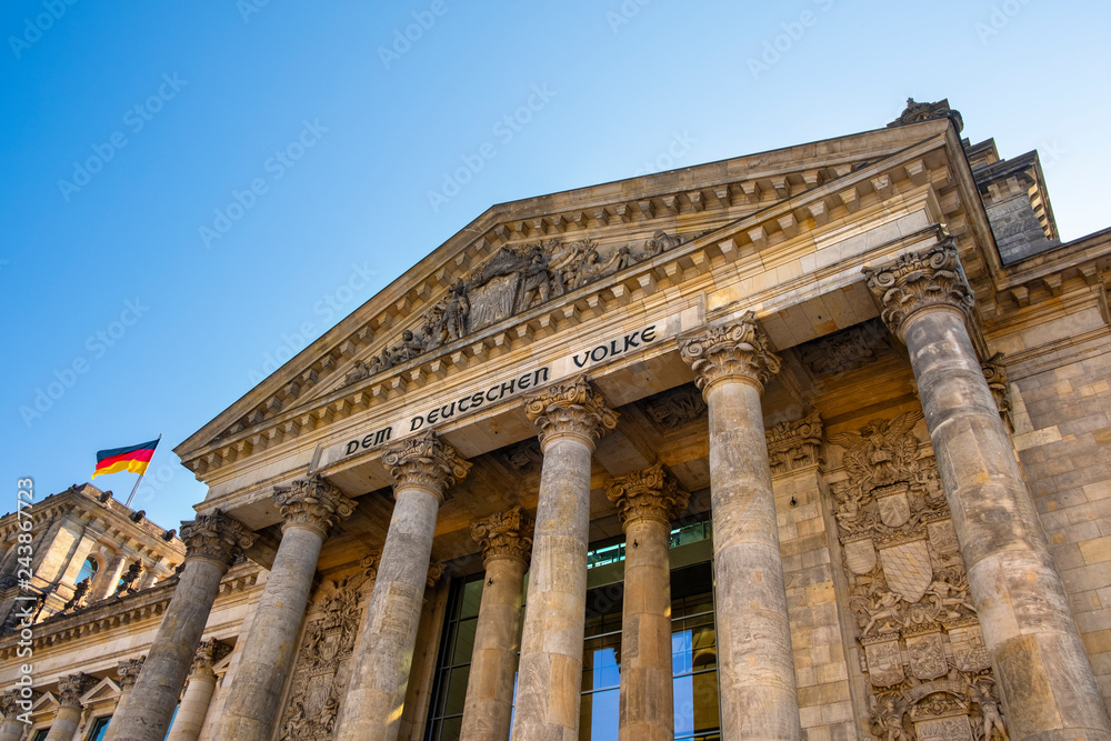 Berlin, Germany - Front view of the historic Reichstag building facade with the monumental colonnade and To The German People - Dem Deutschen Volke - inscription