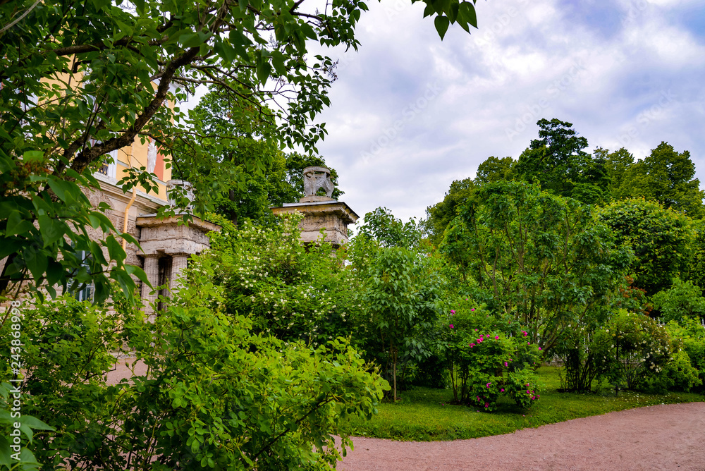 Fragment of Museum of fine arts with garden. Ancient pavilion in Tsarskoye selo Saint Petersburg with public park. Beautiful landscape with blossoming trees, bushes, flowers. Summer travel photo
