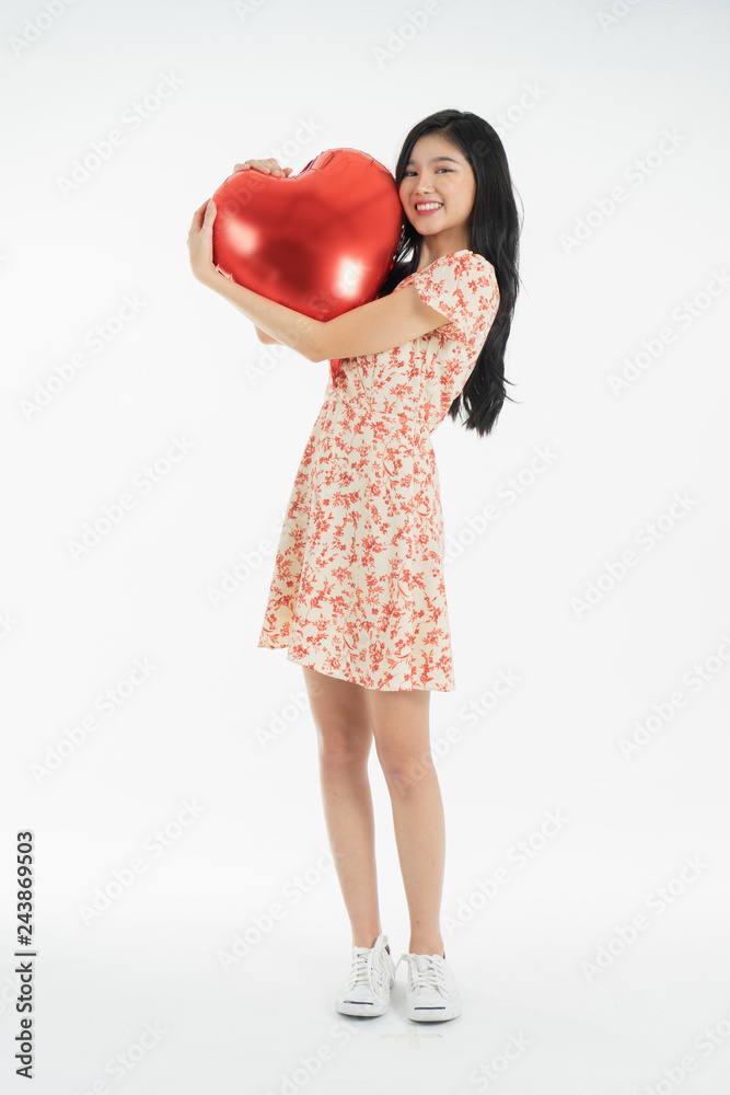 Asian young woman in red dress  red ballon heart. Young woman holding it with  being excited and surprised  holiday present isolated white  background.concept love surprise valentine day.