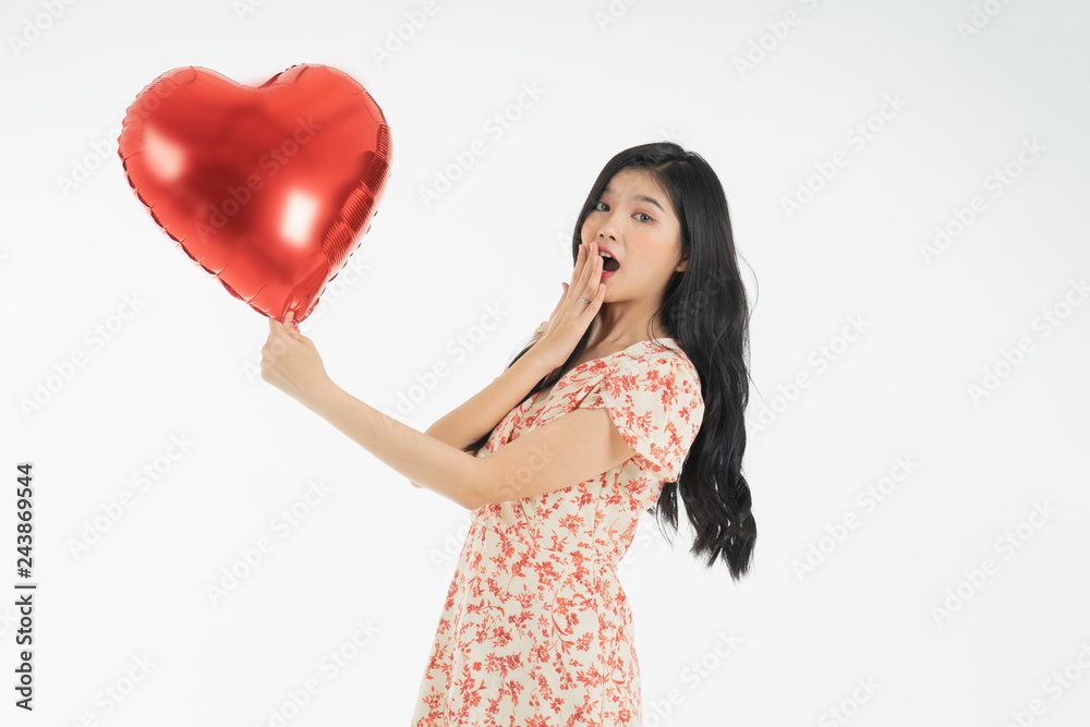 Asian young woman in red dress red ballon heart. Young woman holding it with being excited and surprised holiday present isolated white background.concept love surprise valentine day. Asian young woman in red dress red ballon heart. Young woman holding it with being excited and surprised holiday present isolated white background.concept love surprise valentine day.
