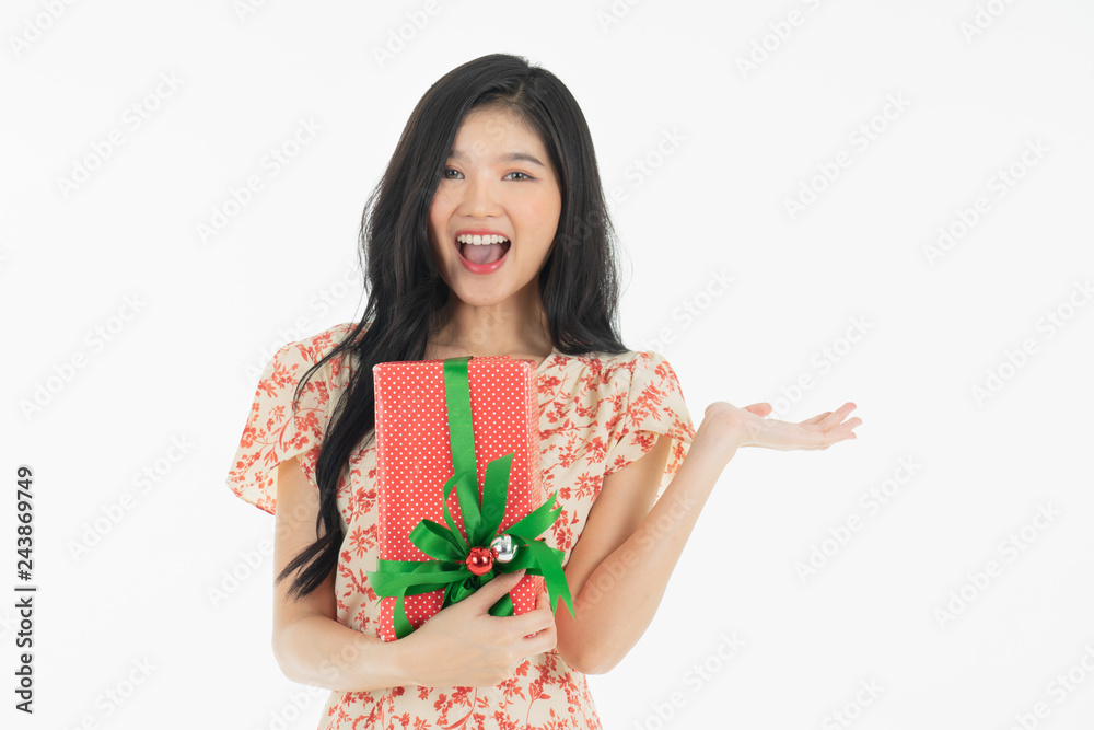 curious woman in red dress rejoicing her birthday or new year gift box. Young woman holding gift box with red bow being excited and surprised holiday present isolated white background curious woman in red dress rejoicing her birthday or new year gift box. Young woman holding gift box with red bow being excited and surprised holiday present isolated white background