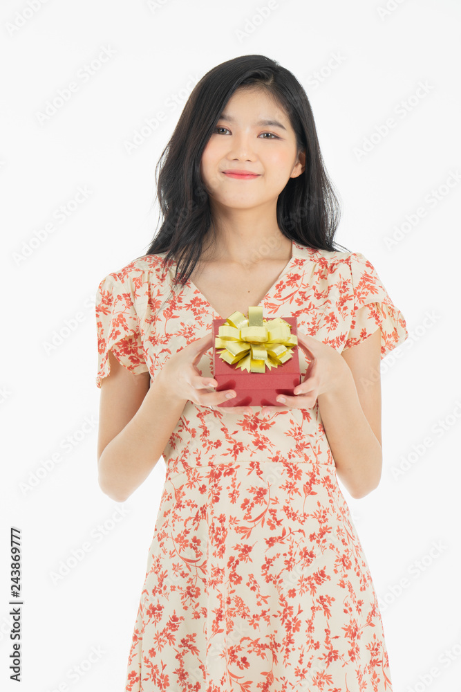 asian curious woman in red dress rejoicing her birthday or new year gift box. Young woman holding gift box with red bow being excited and surprised holiday present isolated white background asian curious woman in red dress rejoicing her birthday or new year gift box. Young woman holding gift box with red bow being excited and surprised holiday present isolated white background