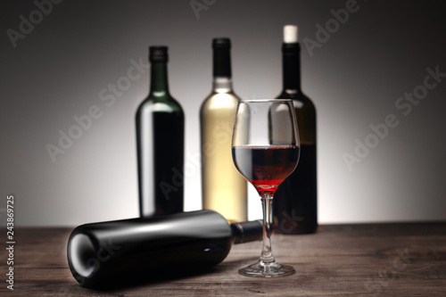 a glass of wine with bottles
