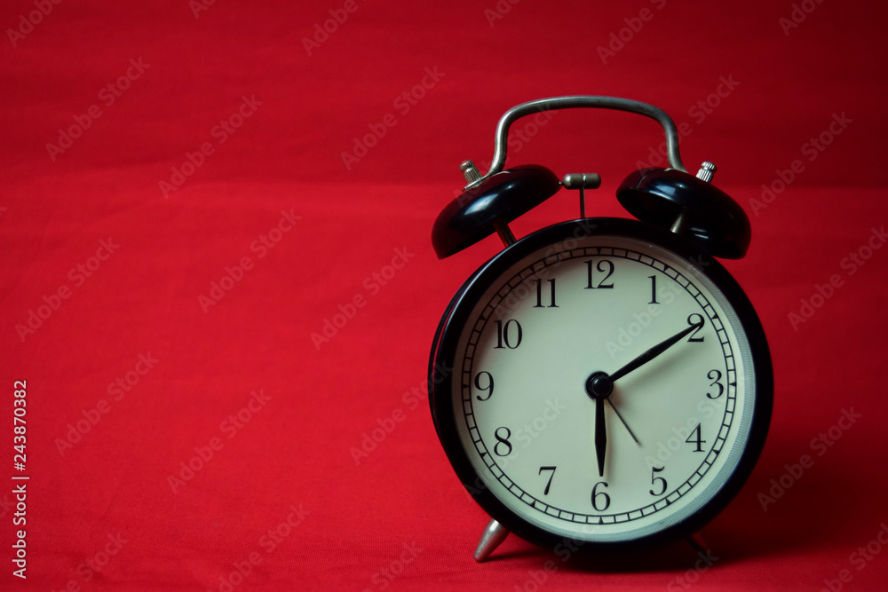 Clock ticking to 6 o'clock on the red background Clock ticking to 6 o'clock on the red background
