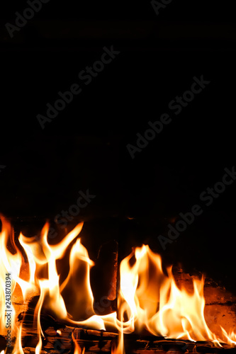 Flames of fire on a black background. The mystery of fire. Space for copy, text, your words. Vertical © OLAYOLA