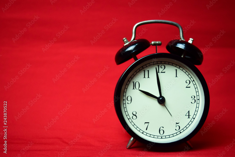 Clock ticking to 10 o'clock on the red background Clock ticking to 10 o'clock on the red background