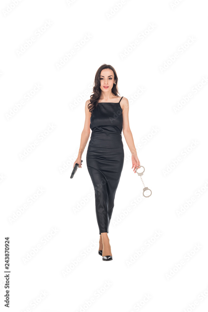 elegant female secret agent in black dress holding gun and handcuffs, isolated on white elegant female secret agent in black dress holding gun and handcuffs, isolated on white