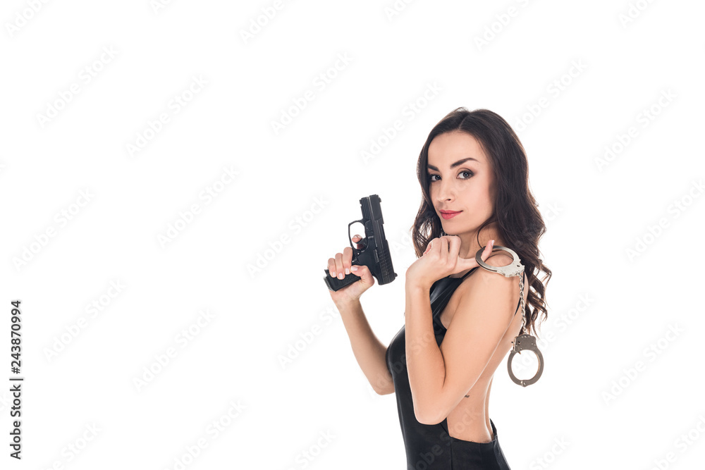 beautiful security agent in black dress holding gun and handcuffs, isolated on white beautiful security agent in black dress holding gun and handcuffs, isolated on white