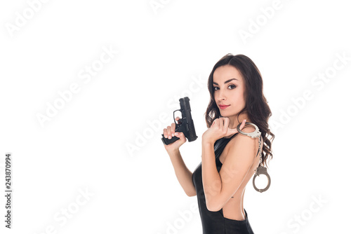 beautiful security agent in black dress holding gun and handcuffs  isolated on white