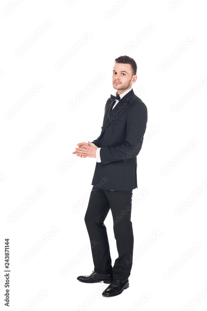 handsome young man posing in black tuxedo and tie bow isolated on white handsome young man posing in black tuxedo and tie bow isolated on white