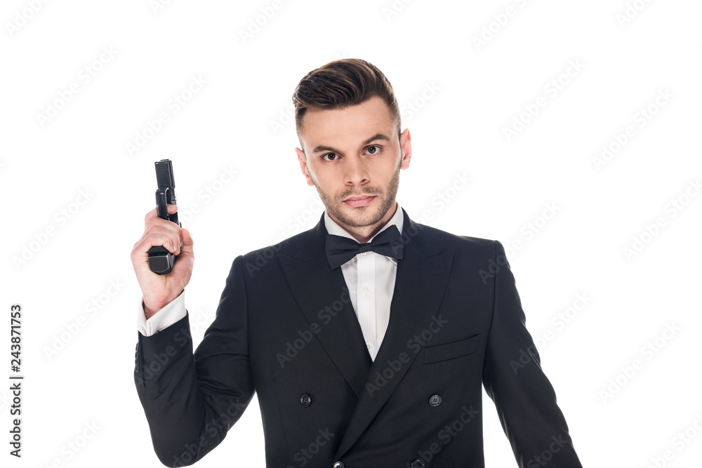 handsome secret agent in black suit and tie bow holding handgun, isolated on white handsome secret agent in black suit and tie bow holding handgun, isolated on white