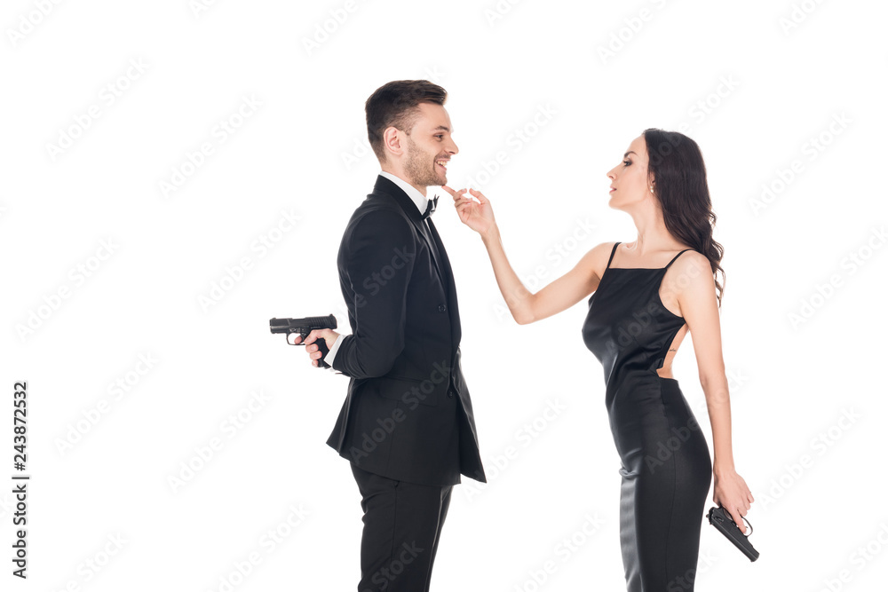 together couple of secret agents in black clothes holding guns, isolated on white together couple of secret agents in black clothes holding guns, isolated on white