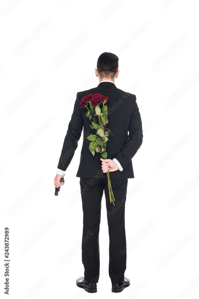 back view of secret agent in black suit holding handgun and red roses, isolated on white back view of secret agent in black suit holding handgun and red roses, isolated on white