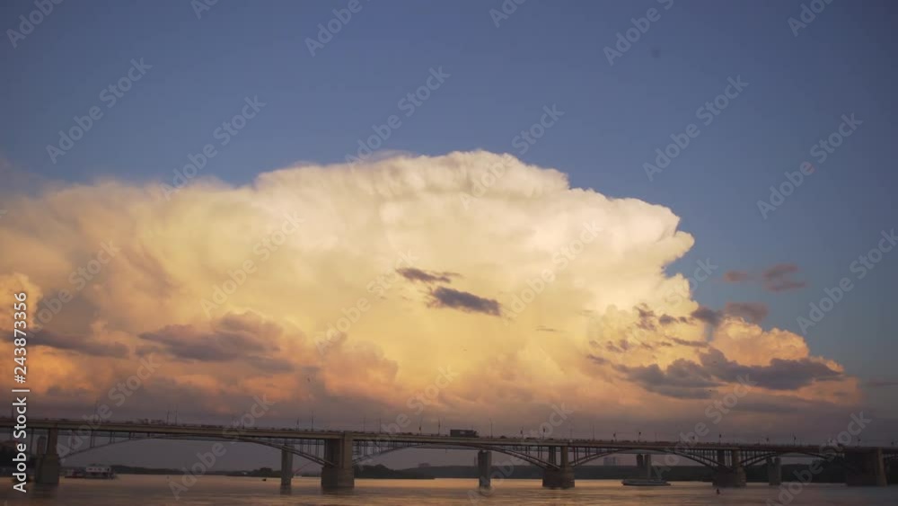 timelapse bridge city clouds. Bridge over the Ob river at Novosibirsk. Urban traffic on the bridge in summer. Cloudy sunset over the river bridge in the city. Timelapse timelapse bridge city clouds. Bridge over the Ob river at Novosibirsk. Urban traffic on the bridge in summer. Cloudy sunset over the river bridge in the city. Timelapse