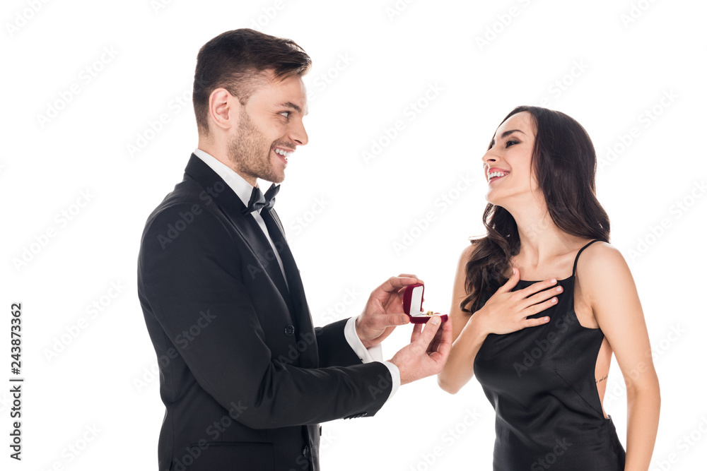 handsome boyfriend giving proposal ring in box to excited girlfriend, isolated on white handsome boyfriend giving proposal ring in box to excited girlfriend, isolated on white
