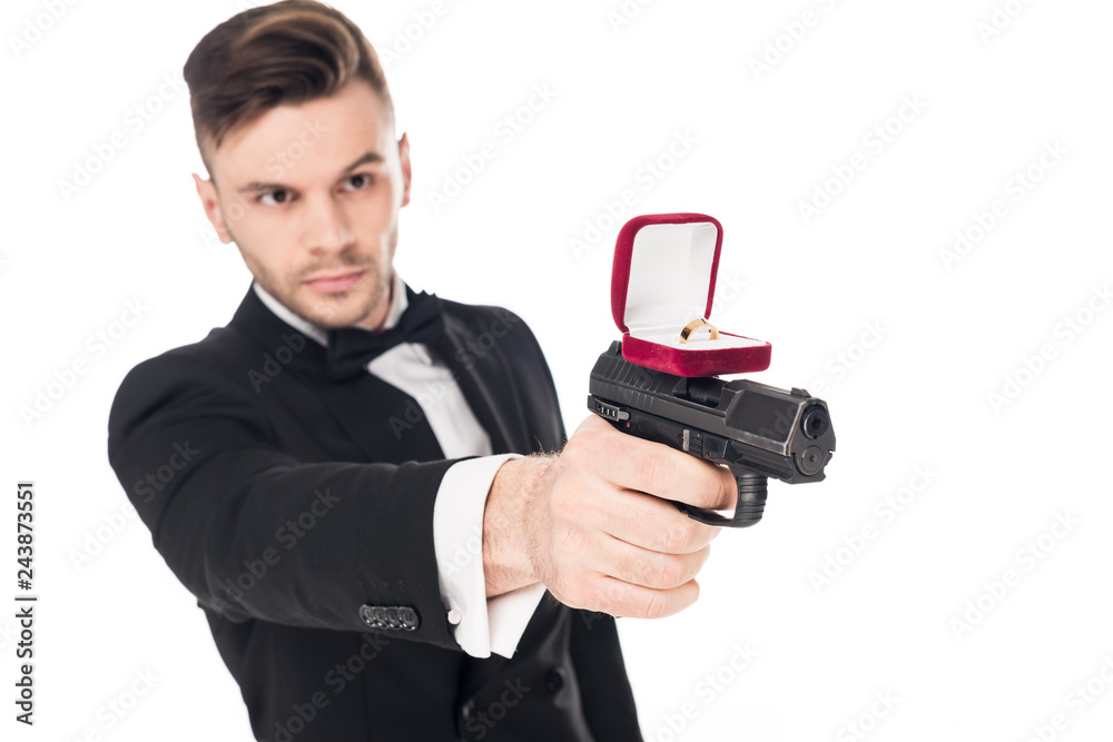male killer in black suit aiming with gun with proposal ring, isolated on white male killer in black suit aiming with gun with proposal ring, isolated on white
