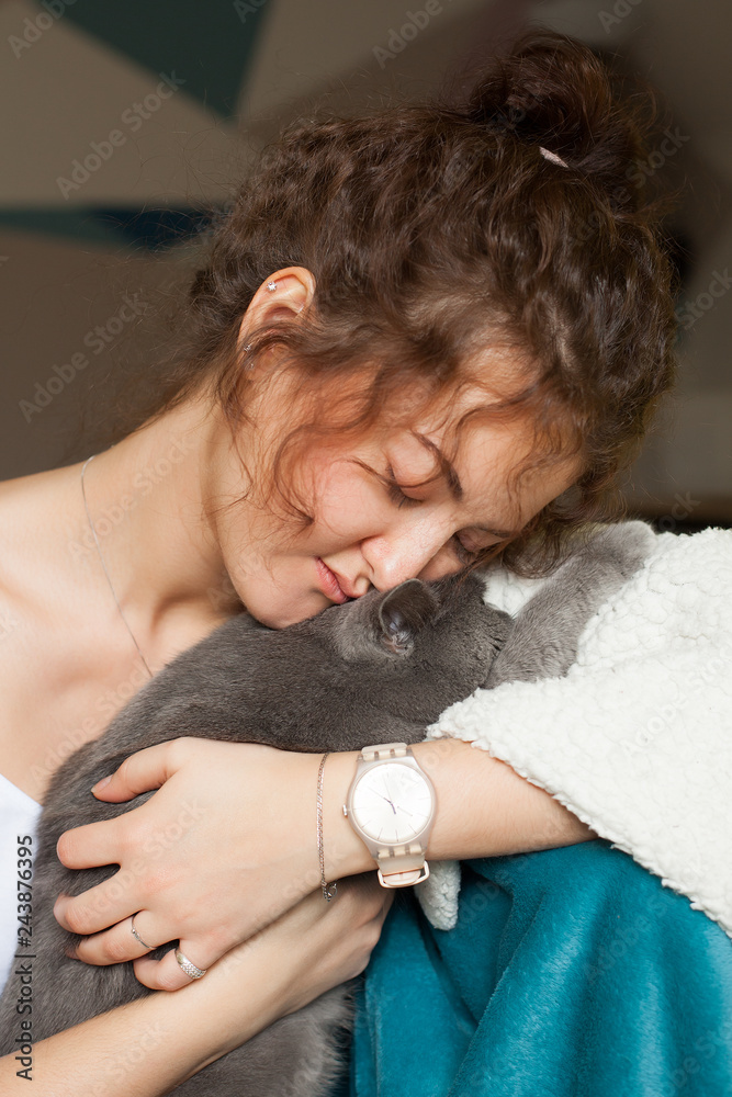 Beautiful girl playing with a gray cat Beautiful girl playing with a gray cat