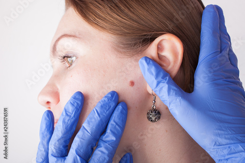 Oncologist examining female patient in clinic. Cancer awareness