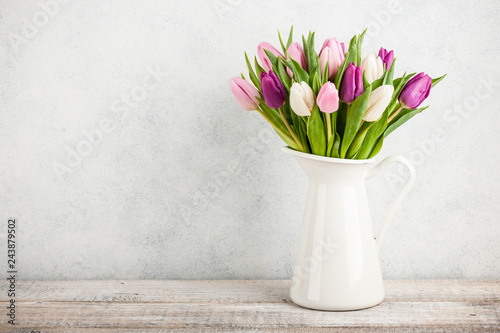 Fresh colorful tulips in a jug