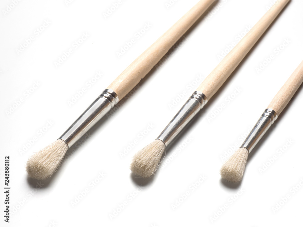 Three paint brushes on white background, closeup Three paint brushes on white background, closeup