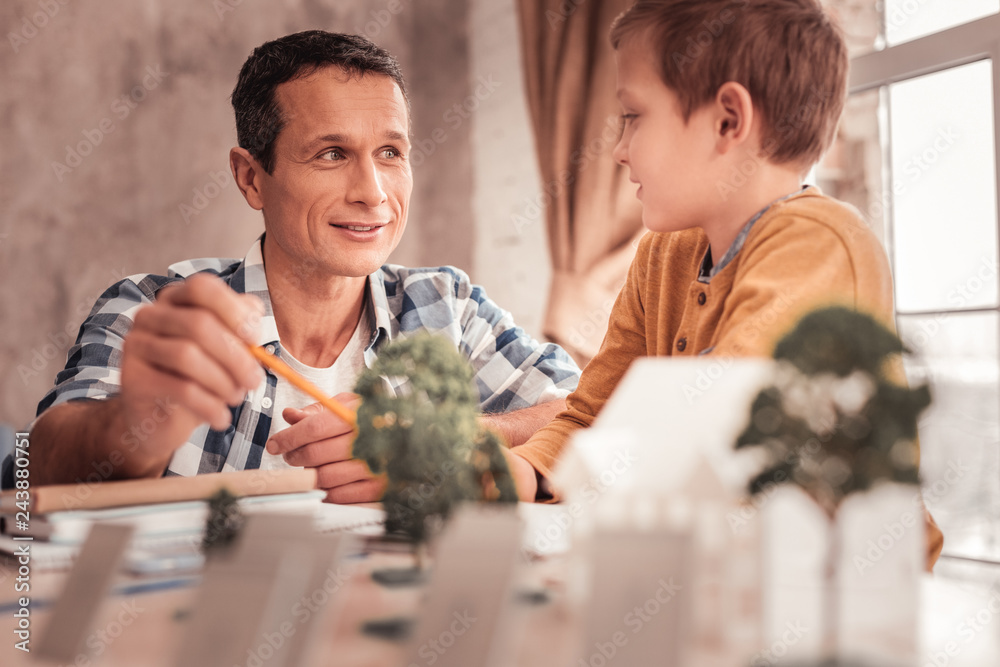 Blonde-haired adopted son asking his father about trees Blonde-haired adopted son asking his father about trees