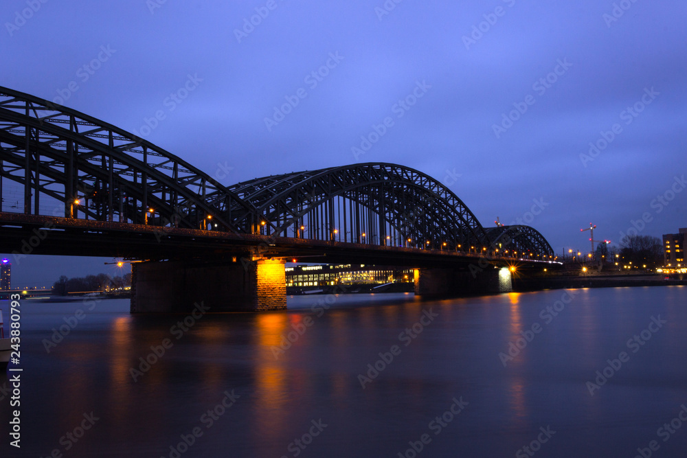 Naklejka premium View of the old Hohenzollern Bridge, the Skyline and a bright, Cologne at Night - Germany, Cologne 2019