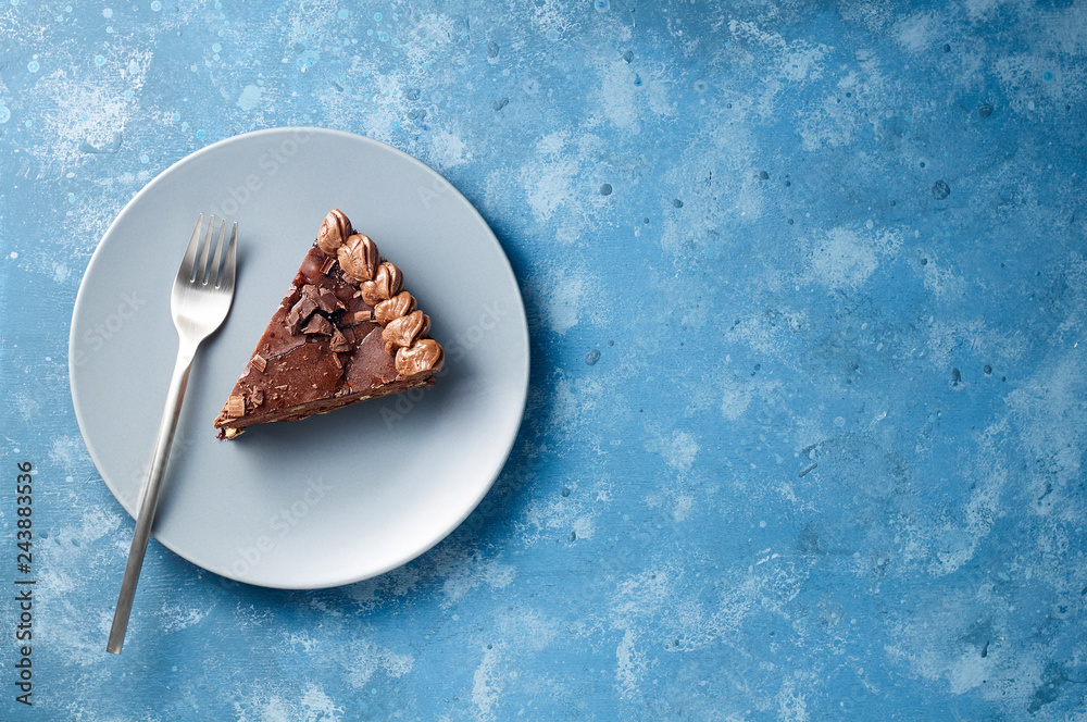 Piece of dark chocolate cake with buttercream, nuts and berry jam