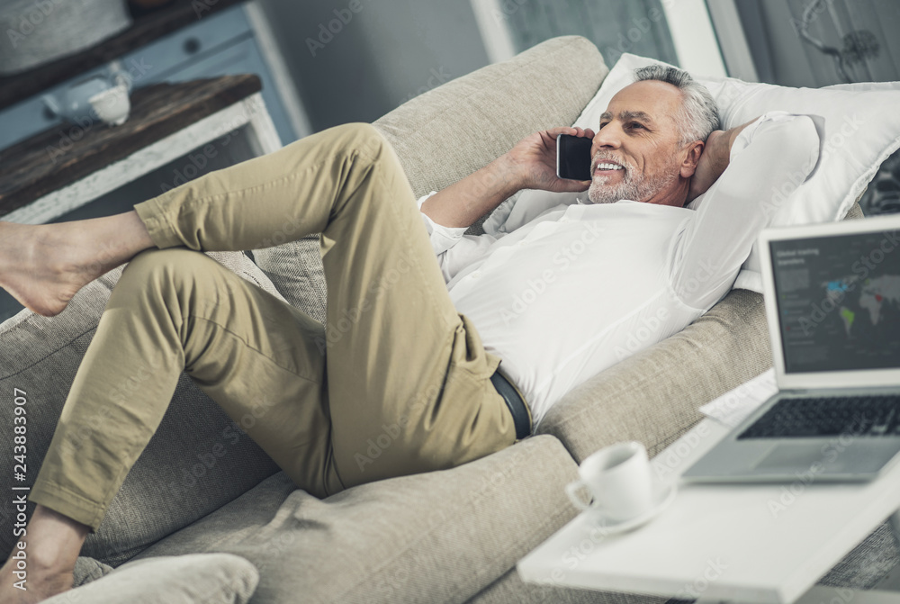 Fototapeta premium Businessman relaxing while lying on sofa