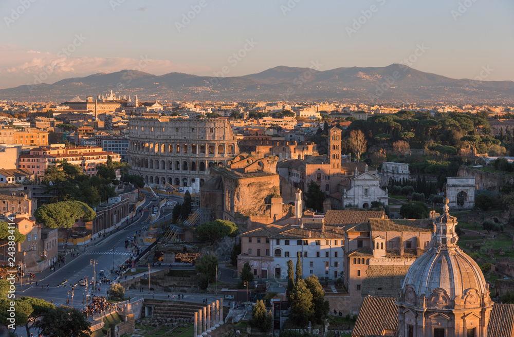 Rome, view of the city in the evening, the Forums, the Colosseum and the mountains.