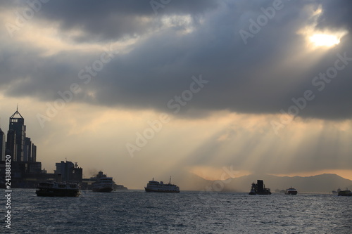 Contre jour in the harbor with the crepuscular rays in hong kong